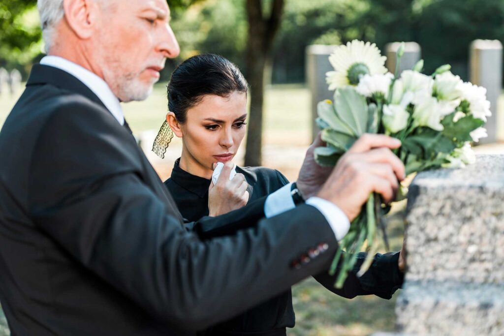Elderly man holding flowers